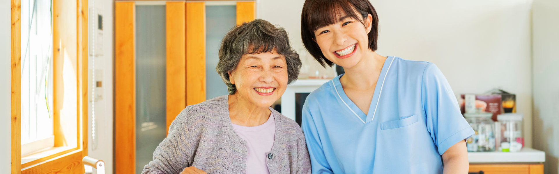 a health professional woman and a senior woman smiling