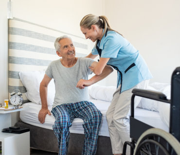 a health professional woman assist a senior man
