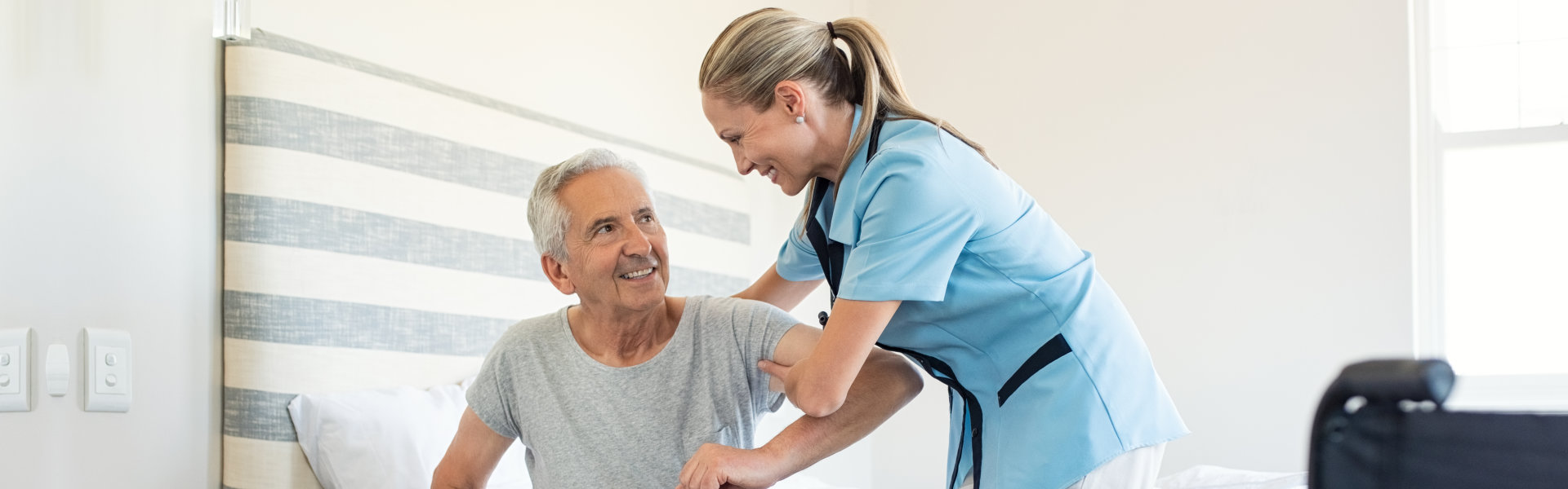 a health professional woman assist a senior man