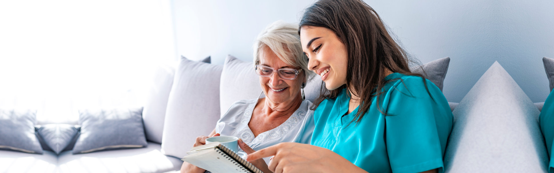 Elderly woman and caregiver smiling